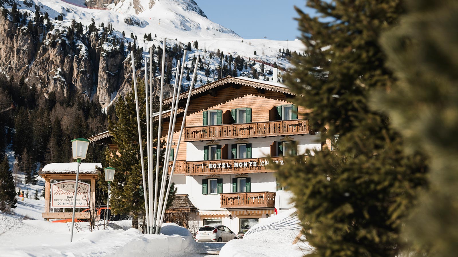 The snowy facade of the Hotel Monte Cherz in Passo Campolongo